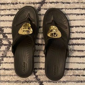 Crocs gold accent flip flops